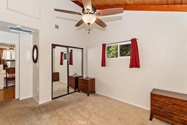 carpeted bedroom with lofted ceiling, ceiling fan, a closet, and wood ceiling