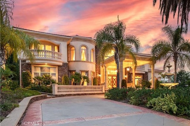 mediterranean / spanish-style home featuring a balcony