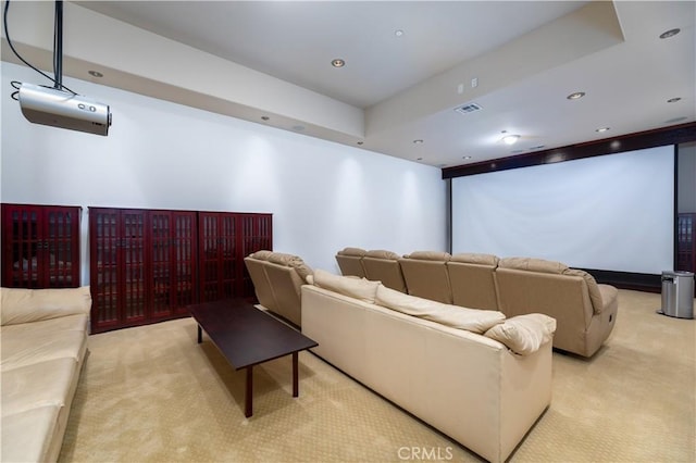 cinema with a raised ceiling and light carpet