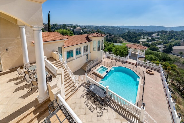 view of pool featuring a gazebo, an in ground hot tub, and a patio