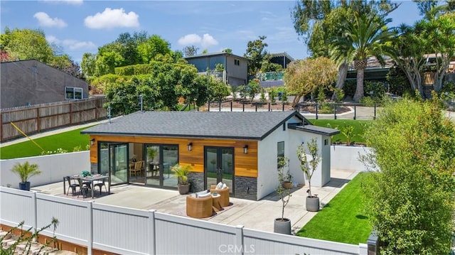 back of property with a patio area and french doors