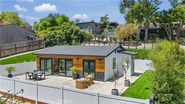 back of property with french doors and a patio area