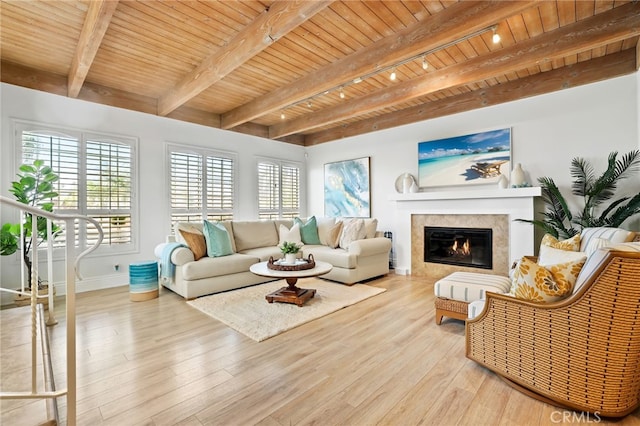 living room with beam ceiling, track lighting, wooden ceiling, and light hardwood / wood-style floors