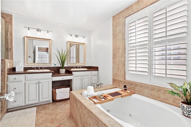 bathroom featuring a relaxing tiled tub, tile patterned floors, and vanity