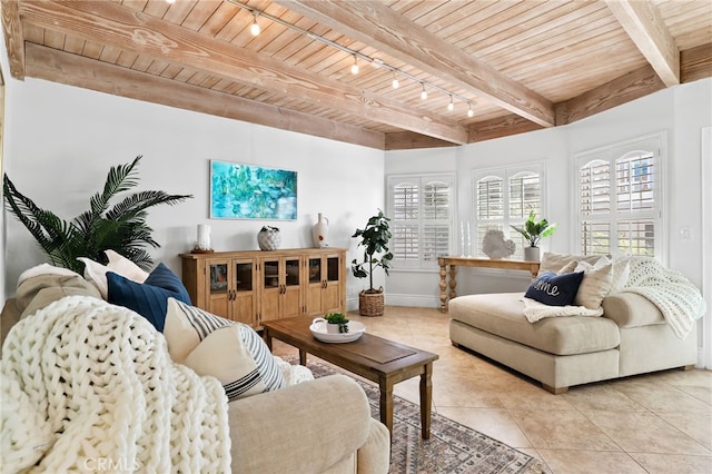 living room with wood ceiling, beam ceiling, rail lighting, and light tile patterned floors