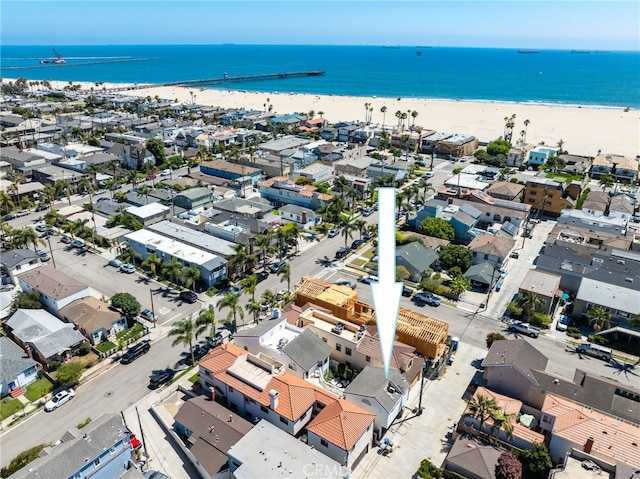 drone / aerial view featuring a water view and a beach view