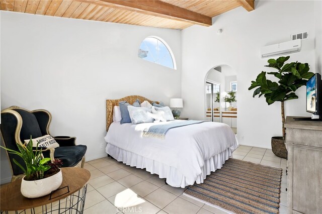 bedroom with beam ceiling, light tile patterned floors, wood ceiling, and a wall unit AC