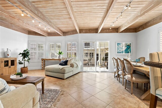 tiled living room with beamed ceiling, track lighting, and wood ceiling