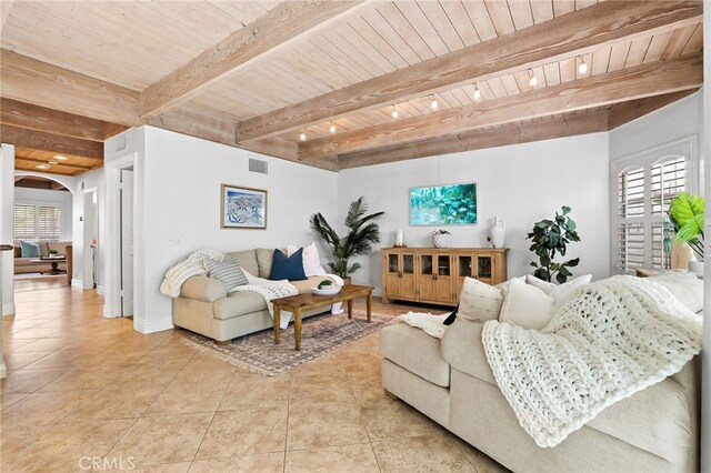 tiled living room featuring beamed ceiling and wooden ceiling