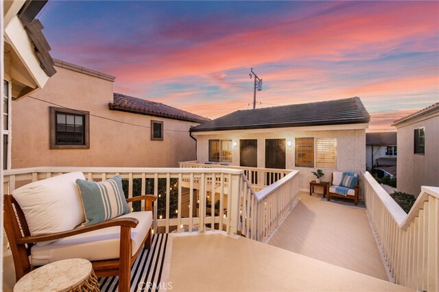 view of balcony at dusk