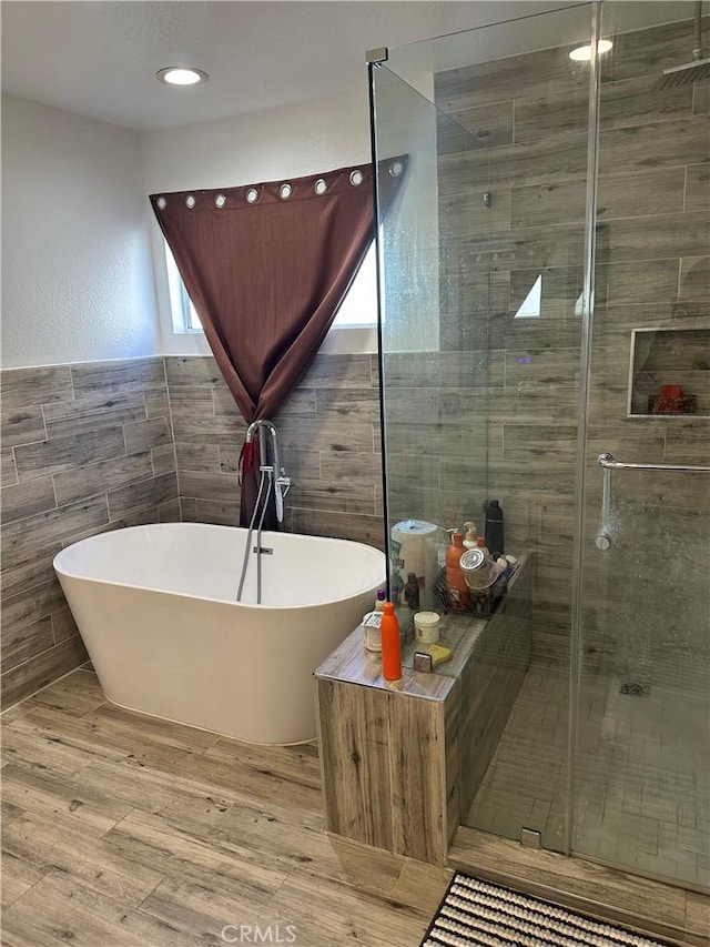 14136 Orizaba Ave, Paramount, CA 90723 - full bath with tile walls, a freestanding bath, a stall shower, and wood finished floors