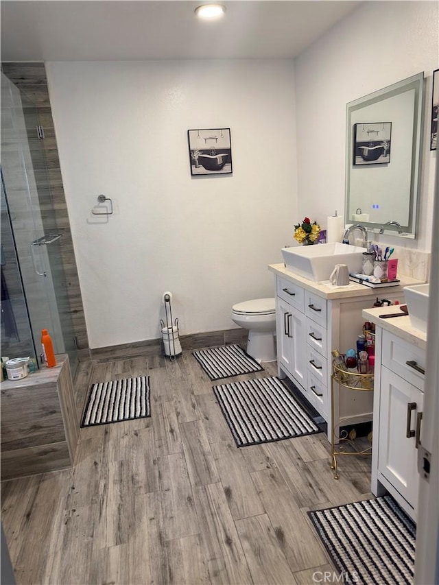 14136 Orizaba Ave, Paramount, CA 90723 - full bathroom with baseboards, toilet, a shower stall, vanity, and wood finished floors