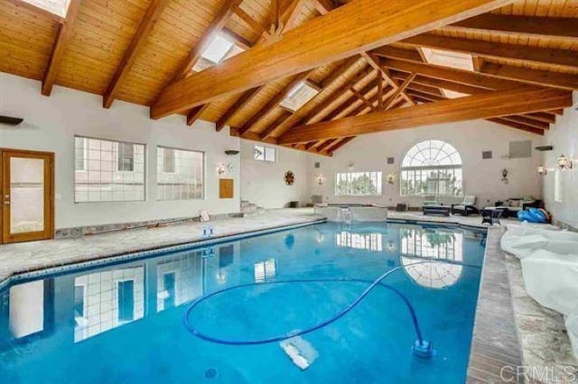 view of swimming pool featuring a skylight