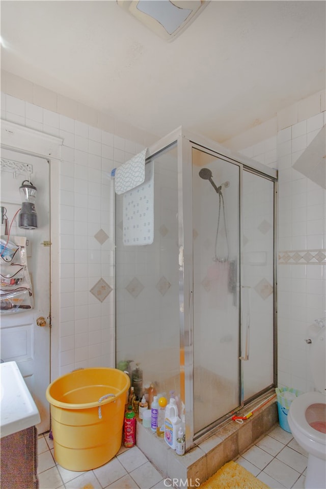 bathroom featuring tile patterned floors, walk in shower, and vanity