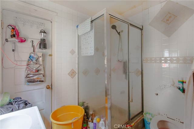 bathroom featuring walk in shower and toilet