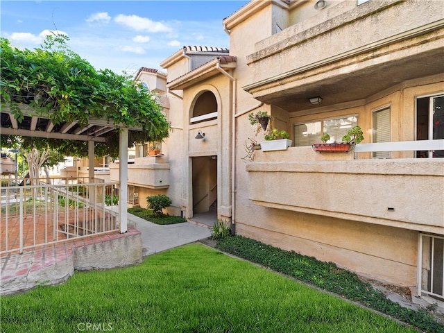 19810 Sandpiper Pl Unit 22, Newhall, CA 91321 - view of exterior entry featuring a tile roof and stucco siding