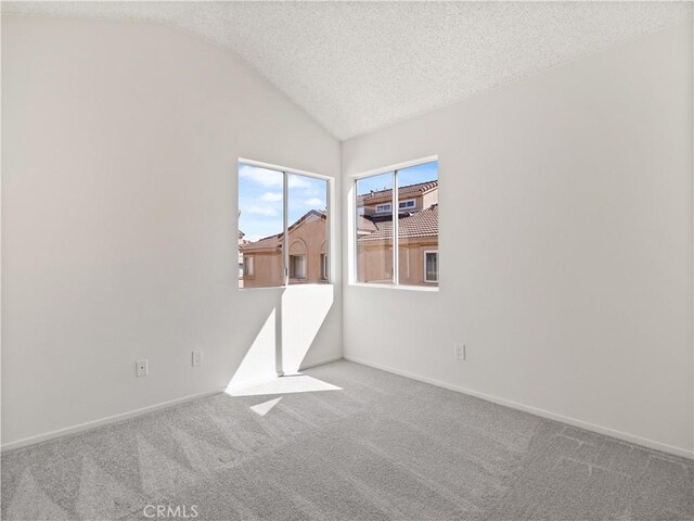 19810 Sandpiper Pl Unit 22, Newhall, CA 91321 - spare room with carpet floors, a textured ceiling, baseboards, and vaulted ceiling