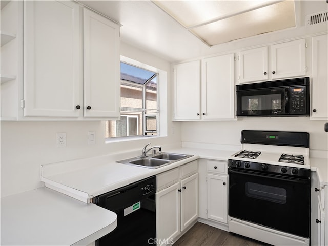 kitchen with white cabinetry, dark hardwood / wood-style floors, sink, and black appliances