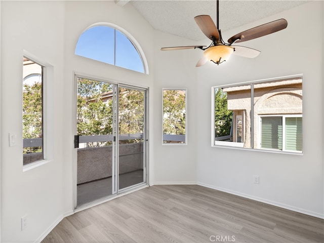 unfurnished sunroom featuring vaulted ceiling and ceiling fan