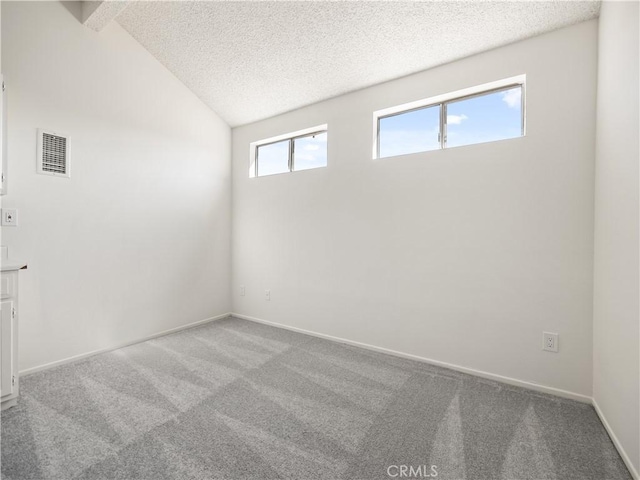 19810 Sandpiper Pl Unit 22, Newhall, CA 91321 - carpeted spare room with a textured ceiling, visible vents, baseboards, and vaulted ceiling