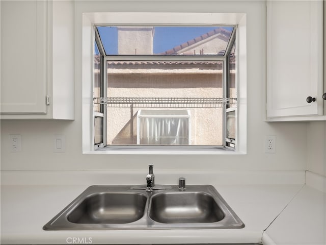 kitchen with white cabinetry and sink