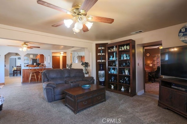 carpeted living room featuring ceiling fan