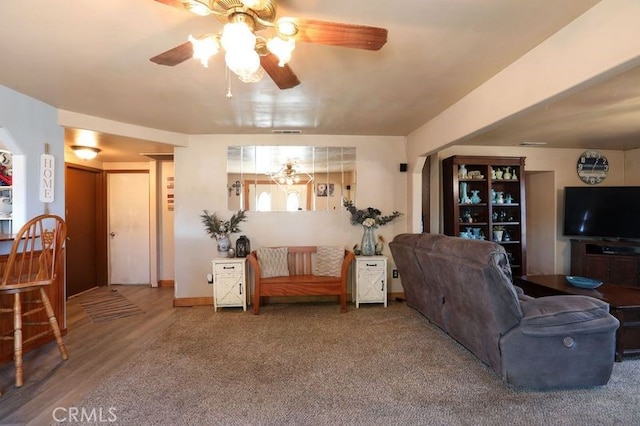 living room featuring hardwood / wood-style flooring and ceiling fan