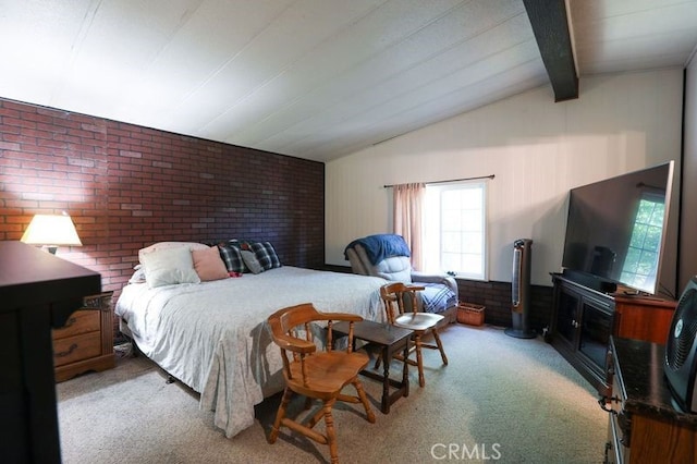 bedroom featuring carpet, lofted ceiling with beams, and brick wall