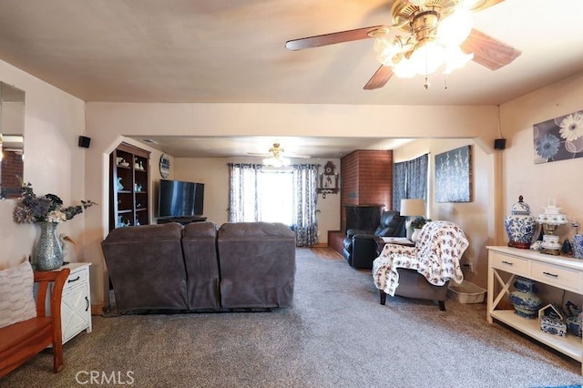 carpeted living room with ceiling fan