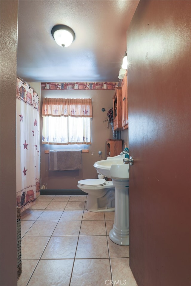 bathroom with tile patterned floors and toilet