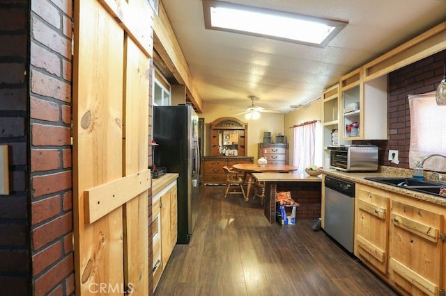 kitchen featuring ceiling fan, sink, brick wall, dark hardwood / wood-style floors, and appliances with stainless steel finishes