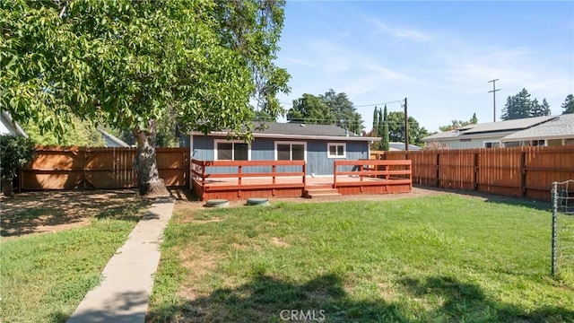 back of house with a yard and a wooden deck