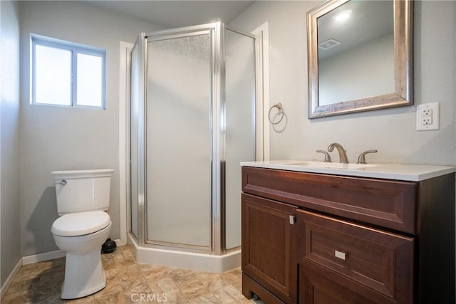 bathroom featuring a shower with shower door, toilet, and vanity