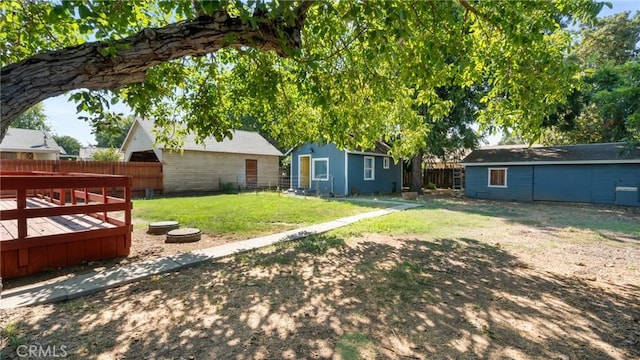 view of yard with a storage shed and a wooden deck