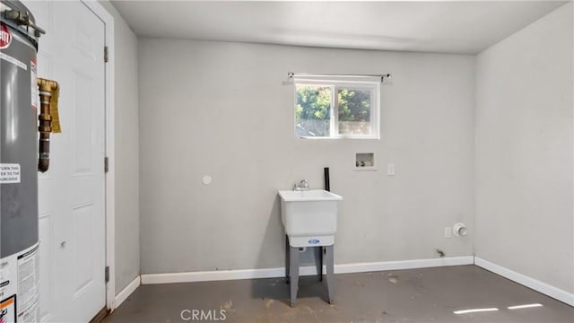 clothes washing area featuring hookup for a washing machine and gas water heater