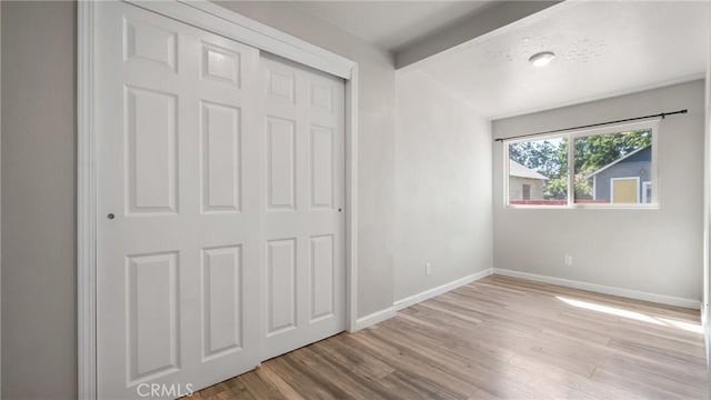 unfurnished bedroom featuring a closet and light hardwood / wood-style floors