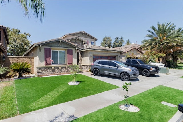 view of front of house with a front yard and a garage