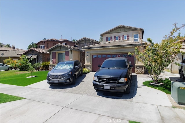 view of front of home with a front yard and a garage