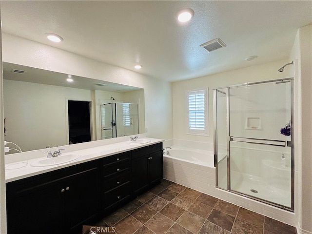 bathroom with plus walk in shower and vanity