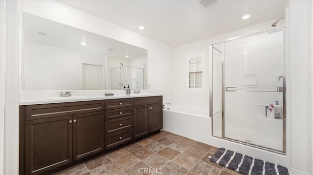 bathroom with vanity and separate shower and tub