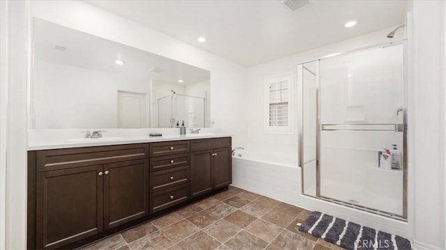 5345 Blue Ridge Way, Fontana, CA 92336 - bathroom featuring a sink, double vanity, stone finish floor, a garden tub, and a stall shower