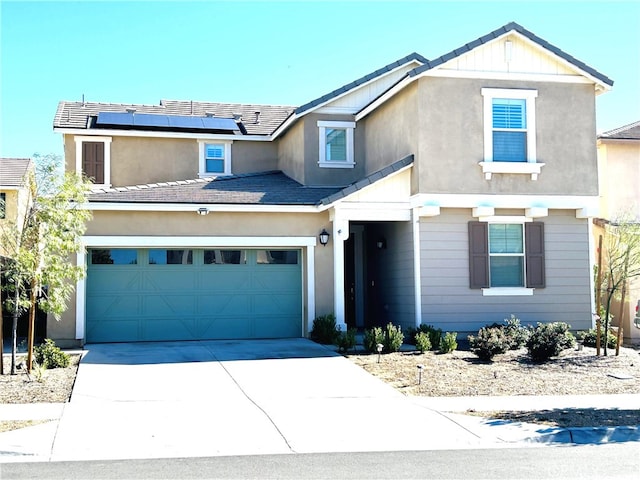 view of front of house with a garage and solar panels