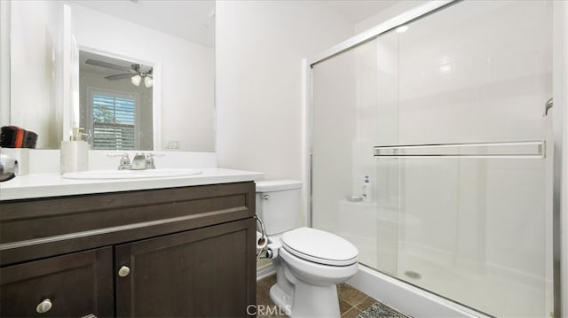 bathroom with vanity, ceiling fan, an enclosed shower, toilet, and tile patterned floors