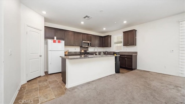 5345 Blue Ridge Way, Fontana, CA 92336 - kitchen featuring visible vents, dark brown cabinets, an island with sink, a sink, and stainless steel appliances