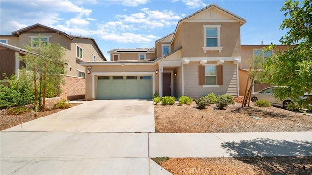 5345 Blue Ridge Way, Fontana, CA 92336 - view of front of home with concrete driveway, stucco siding, and solar panels