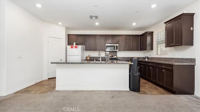 5345 Blue Ridge Way, Fontana, CA 92336 - kitchen with visible vents, a sink, freestanding refrigerator, stainless steel microwave, and light carpet