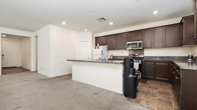 5345 Blue Ridge Way, Fontana, CA 92336 - kitchen featuring visible vents, dark brown cabinets, an island with sink, recessed lighting, and stainless steel appliances