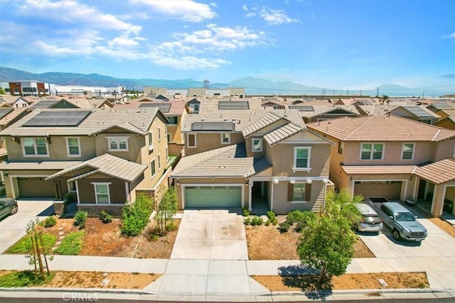 5345 Blue Ridge Way, Fontana, CA 92336 - view of front of home with a residential view, a mountain view, stucco siding, and concrete driveway