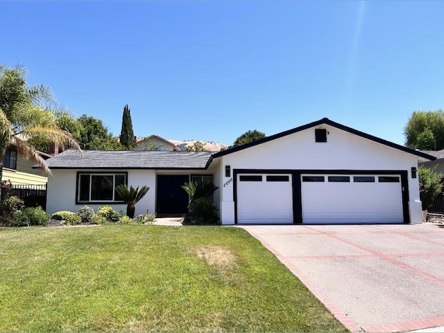 ranch-style house with a garage and a front lawn