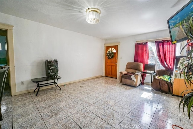 sitting room featuring tile patterned floors and baseboards